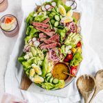 seared ahi tuna salad displayed on a brown serving platter