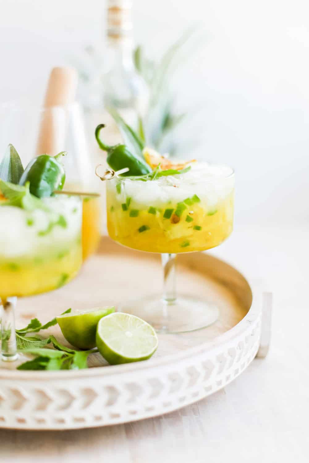 Pineapple jalapeno margaritas in a fancy margarita glass. 