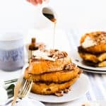 A stack of Pumpkin Spice French Toast on a plate with syrup being poured.