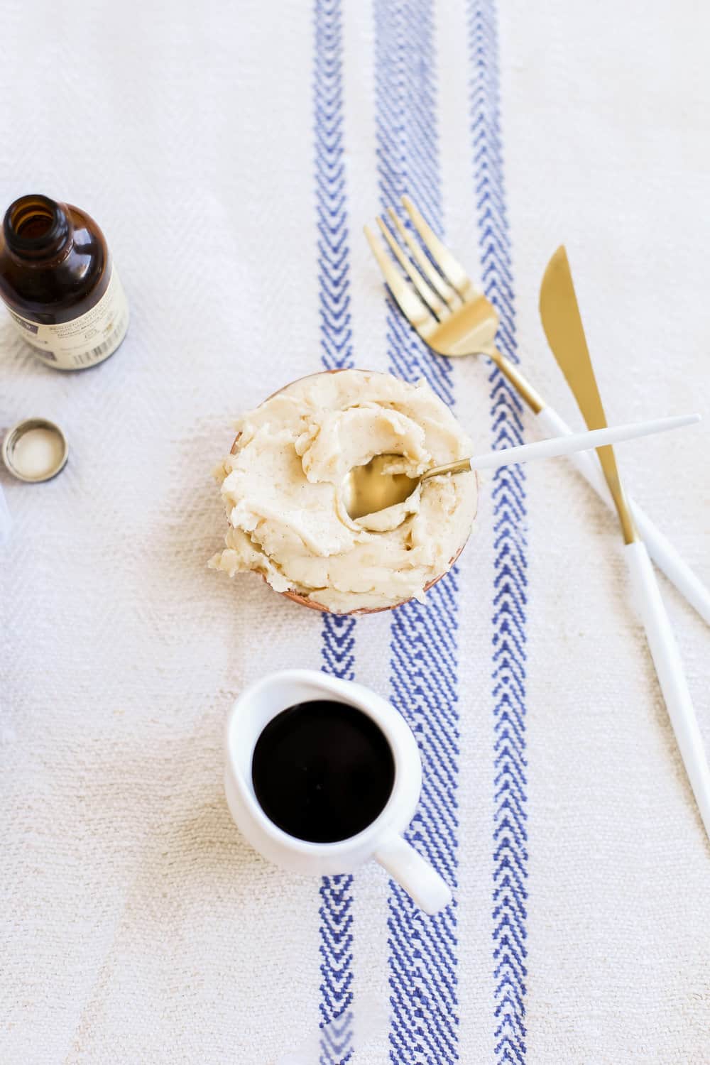 A bowl of whipped maple butter with a gold spoon in the bowl. 