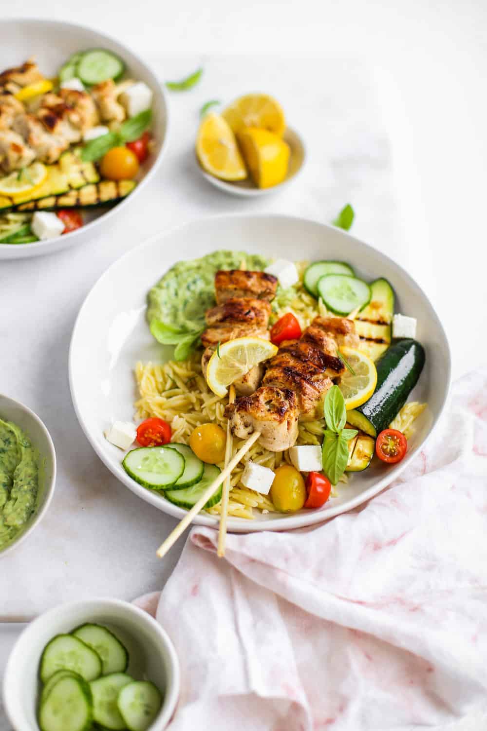 Lemon Garlic Chicken Skewer Bowls with orzo and green goddess dressing in a white bowl