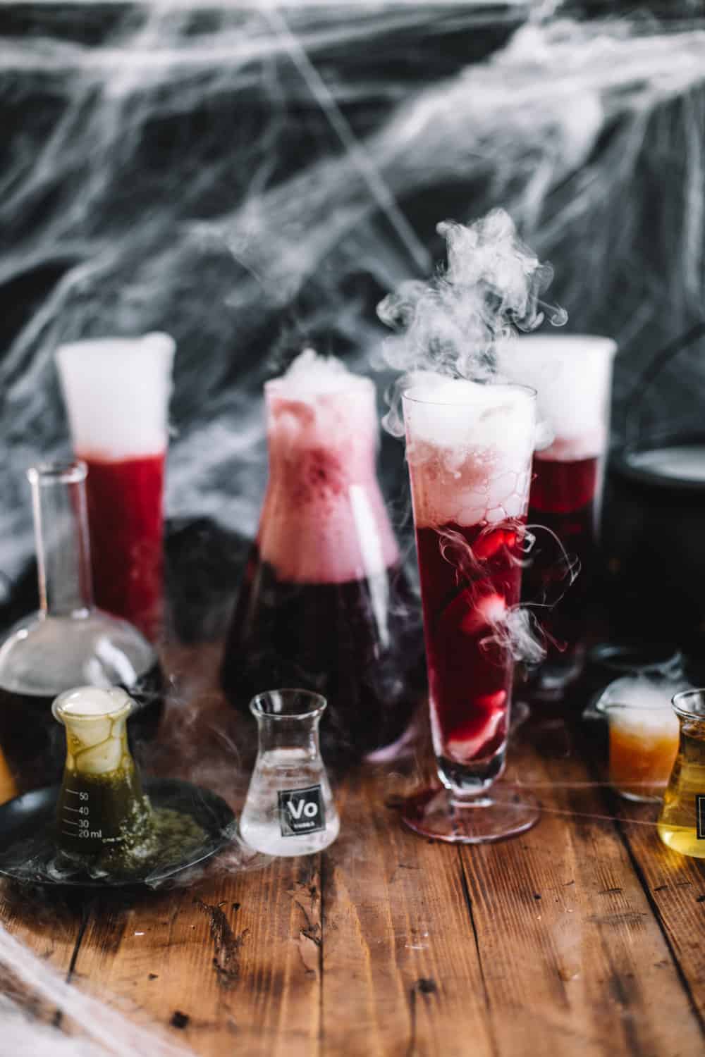 Tall glasses filled with dry ice and Pomegranate Polyjuice Potion