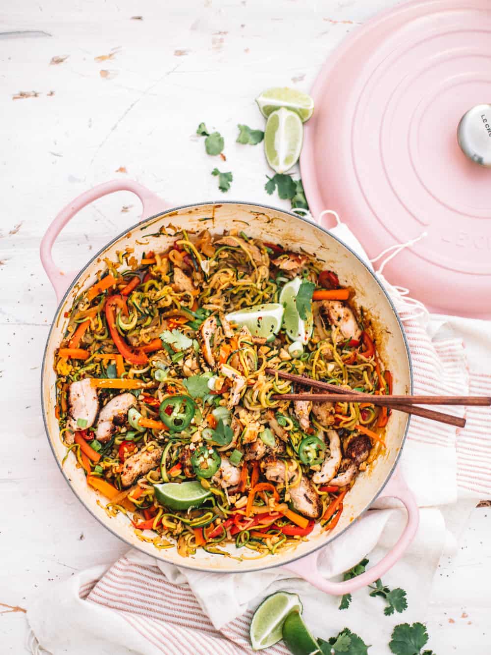 Healthy Chicken Pad Thai with Zoodles in a pink pan with chopsticks.