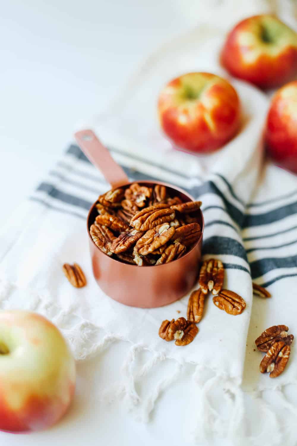 A cup of pecans in a measuring cup. 