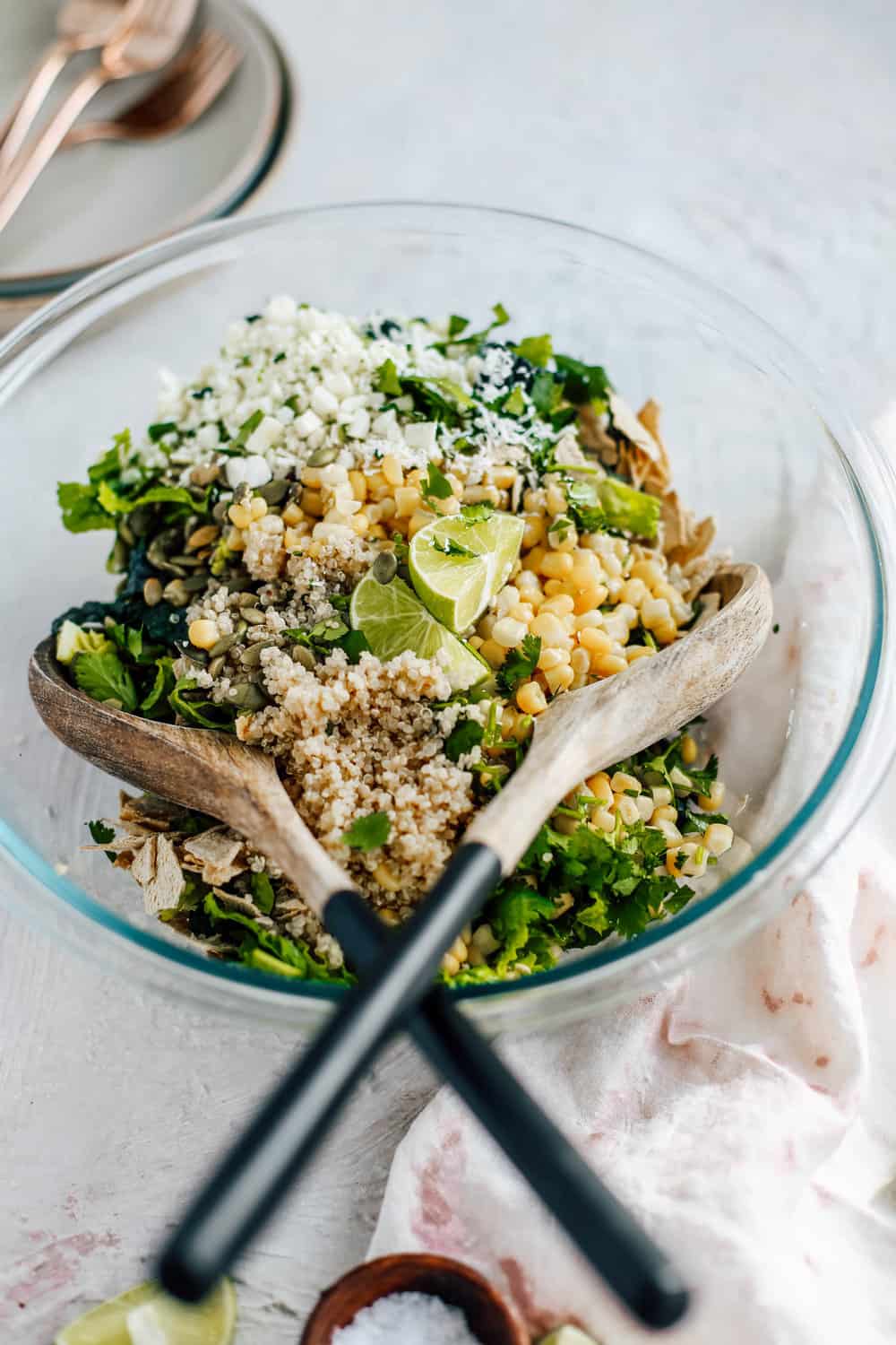 Kale Romaine Golden Corn Quinoa Cilantro and Lime Ingredients in a Clear Mixing Bowl