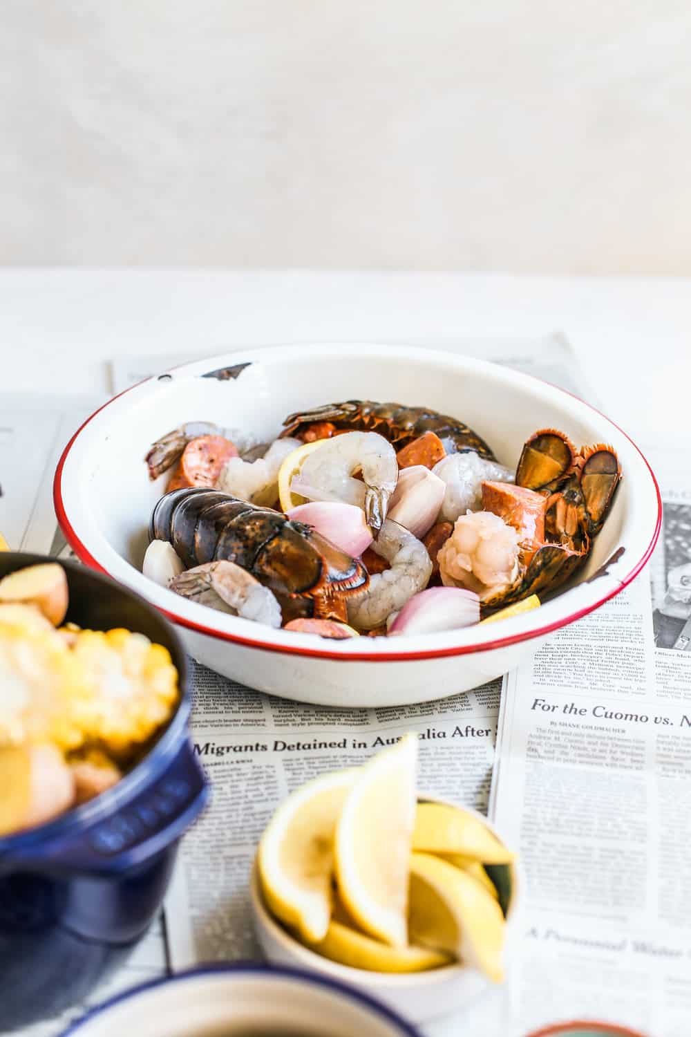 lobster, shrimp, clams in white bowl