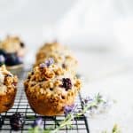 blackberry rhubarb muffins on a black cooling rack