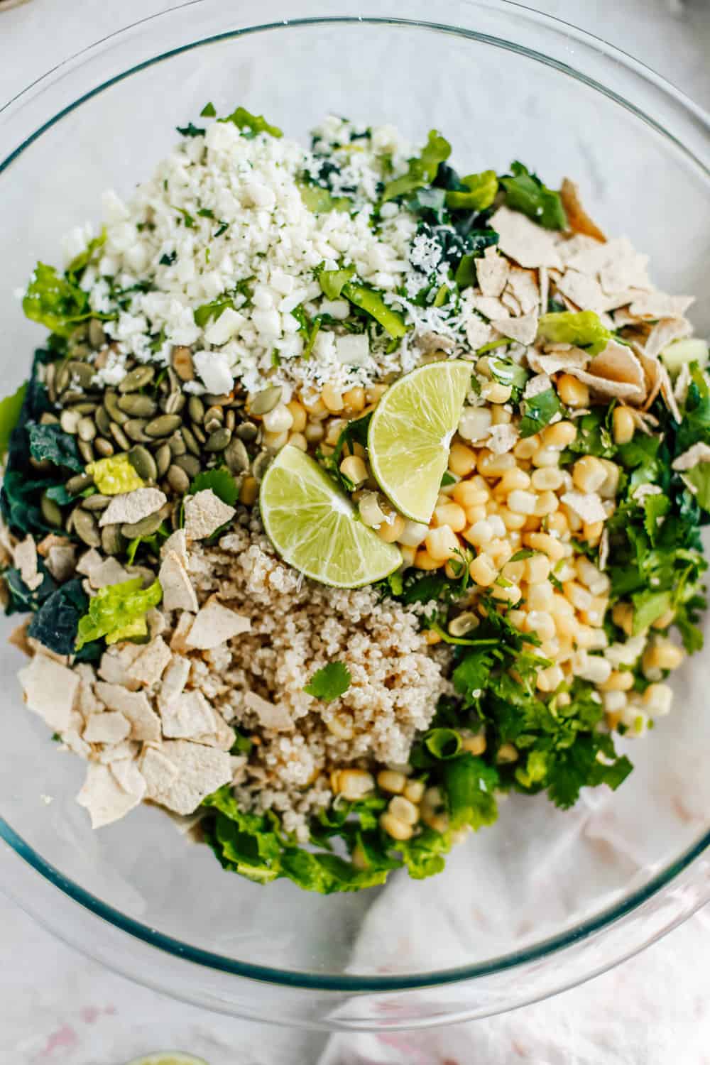 Kale Romaine Golden Corn Quinoa Cilantro and Lime Ingredients in a Clear Mixing Bowl