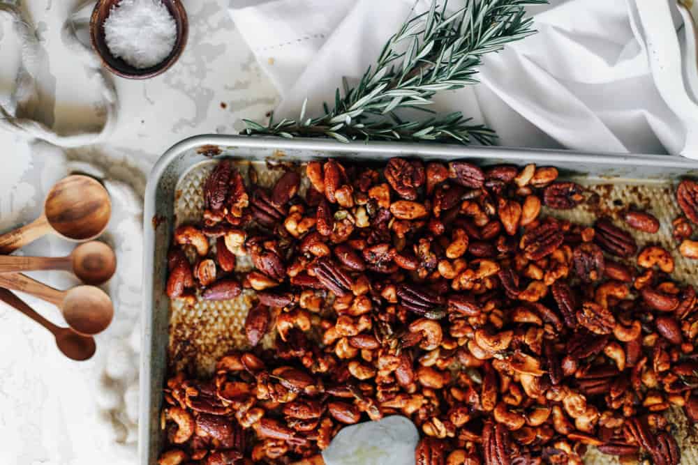 Baked mixed nuts on a large baking sheet.