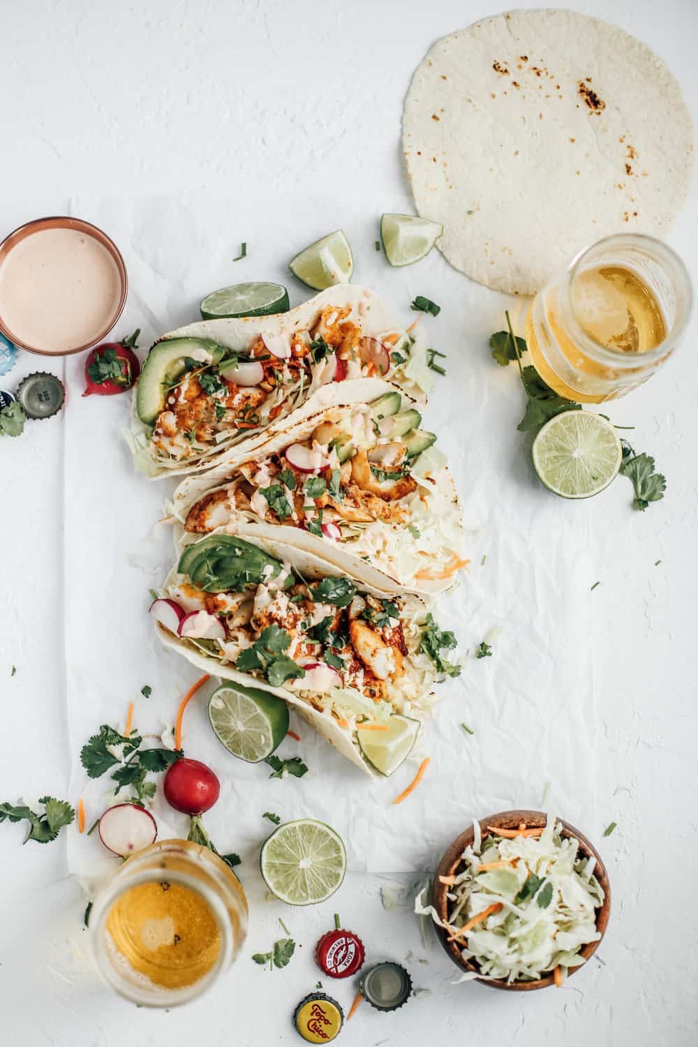 Three blackened cod tacos with two glasses of beer.