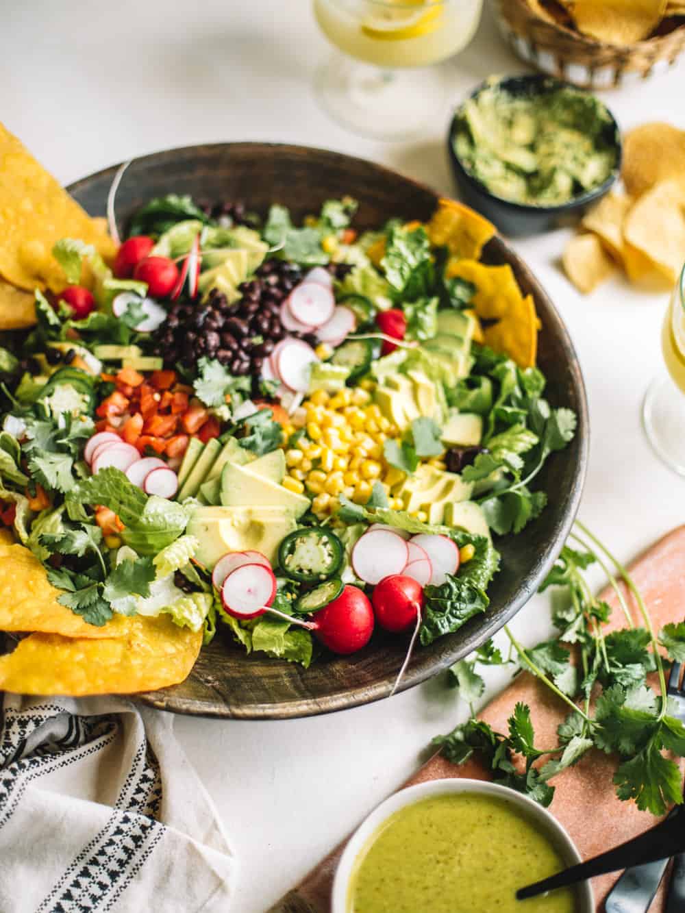 A big wooden bowl of Chopped Tostada Salad with Avocado Cilantro Dressing