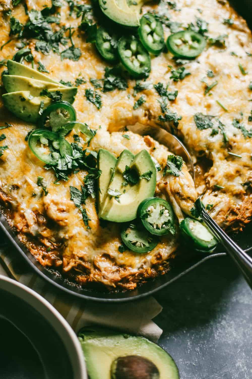 Green Chili Enchilada Cornbread Casserole with a spoon in it. 