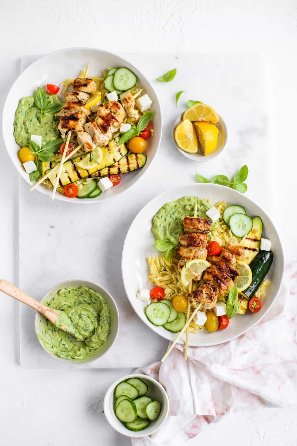 Lemon Garlic Chicken Skewer Bowls with orzo and green goddess dressing in a white bowl