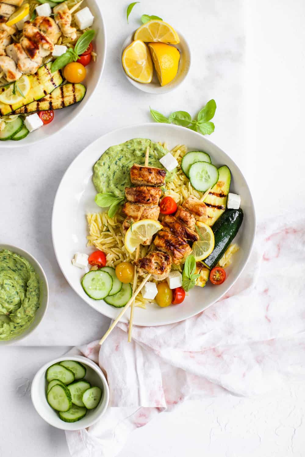 Lemon Garlic Chicken Skewer Bowls with orzo and green goddess dressing in a white bowl