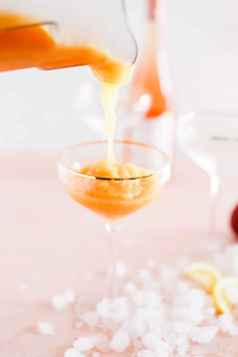 Strawberry Peach Frose being poured from a Blender into a Couple Glass