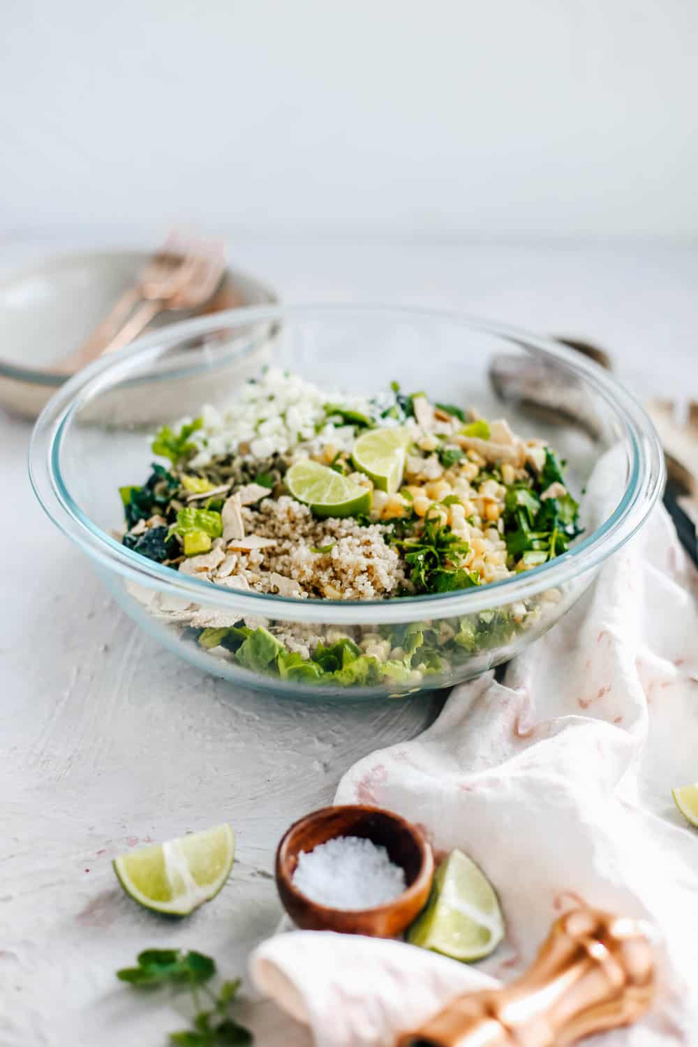 Kale Romaine Golden Corn Quinoa Cilantro and Lime Ingredients in a Clear Mixing Bowl