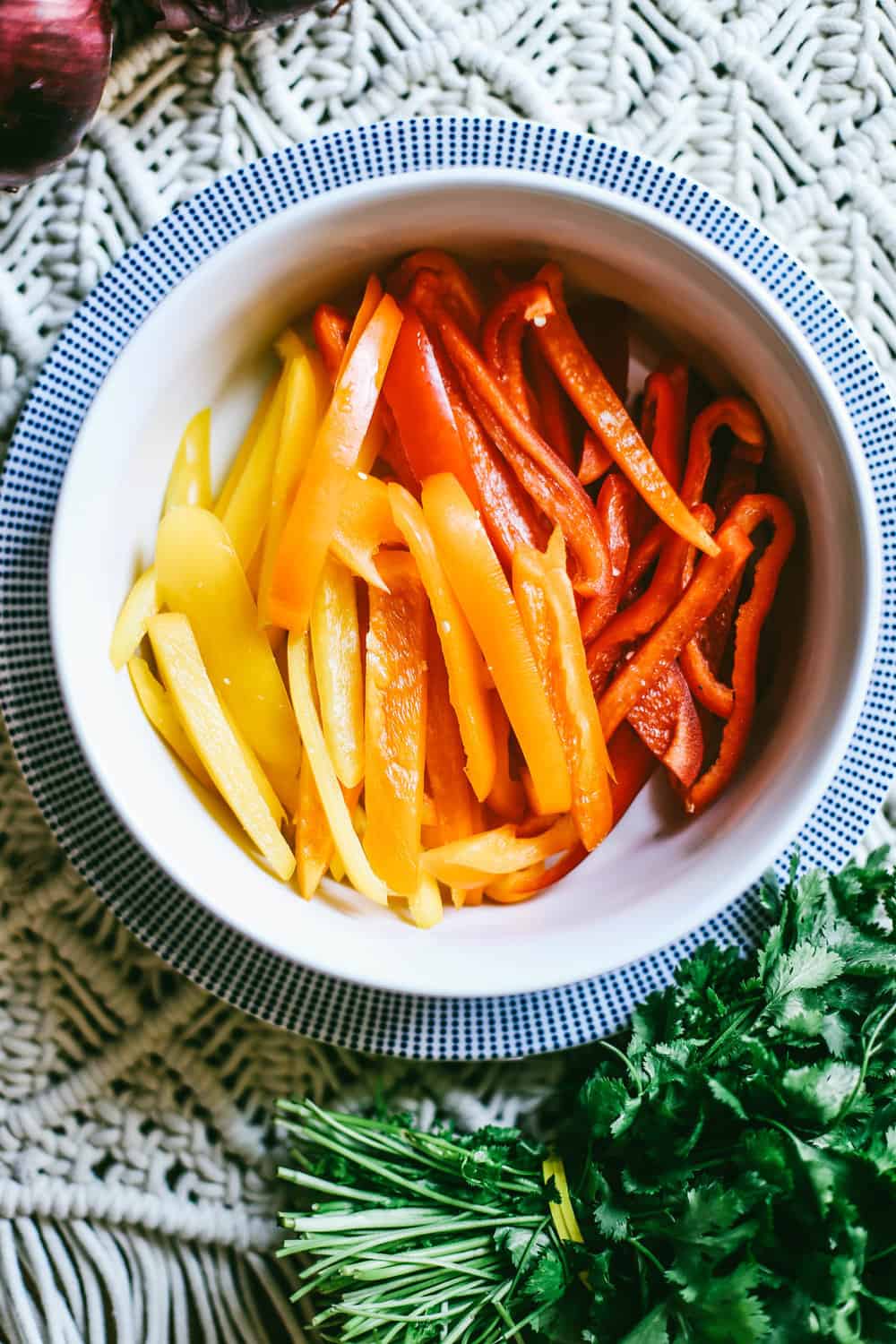 sliced rainbow peppers in white bowl