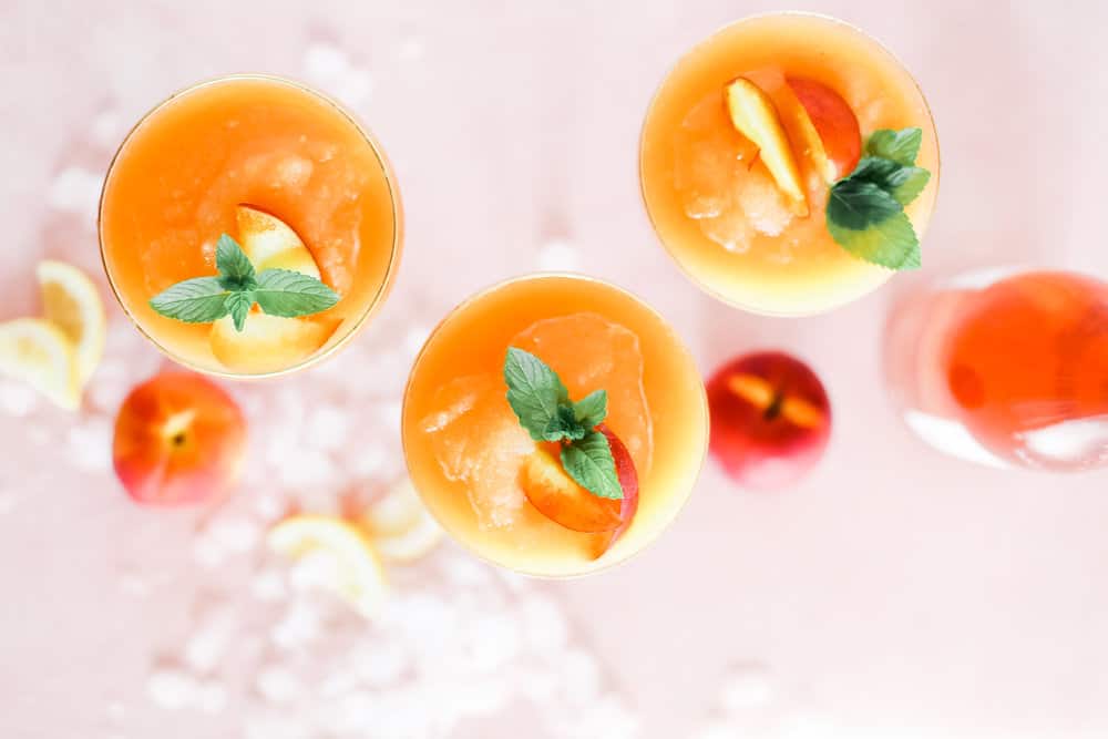 Overhead of Strawberry Peach Frose in Coupe Glasses with Mint