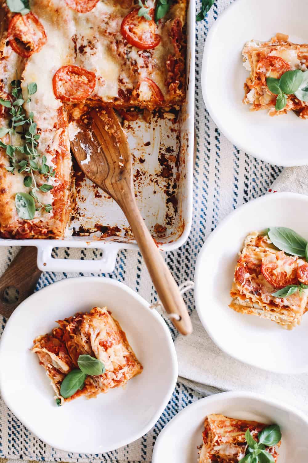 Servings of homemade lasagna in white bowls.