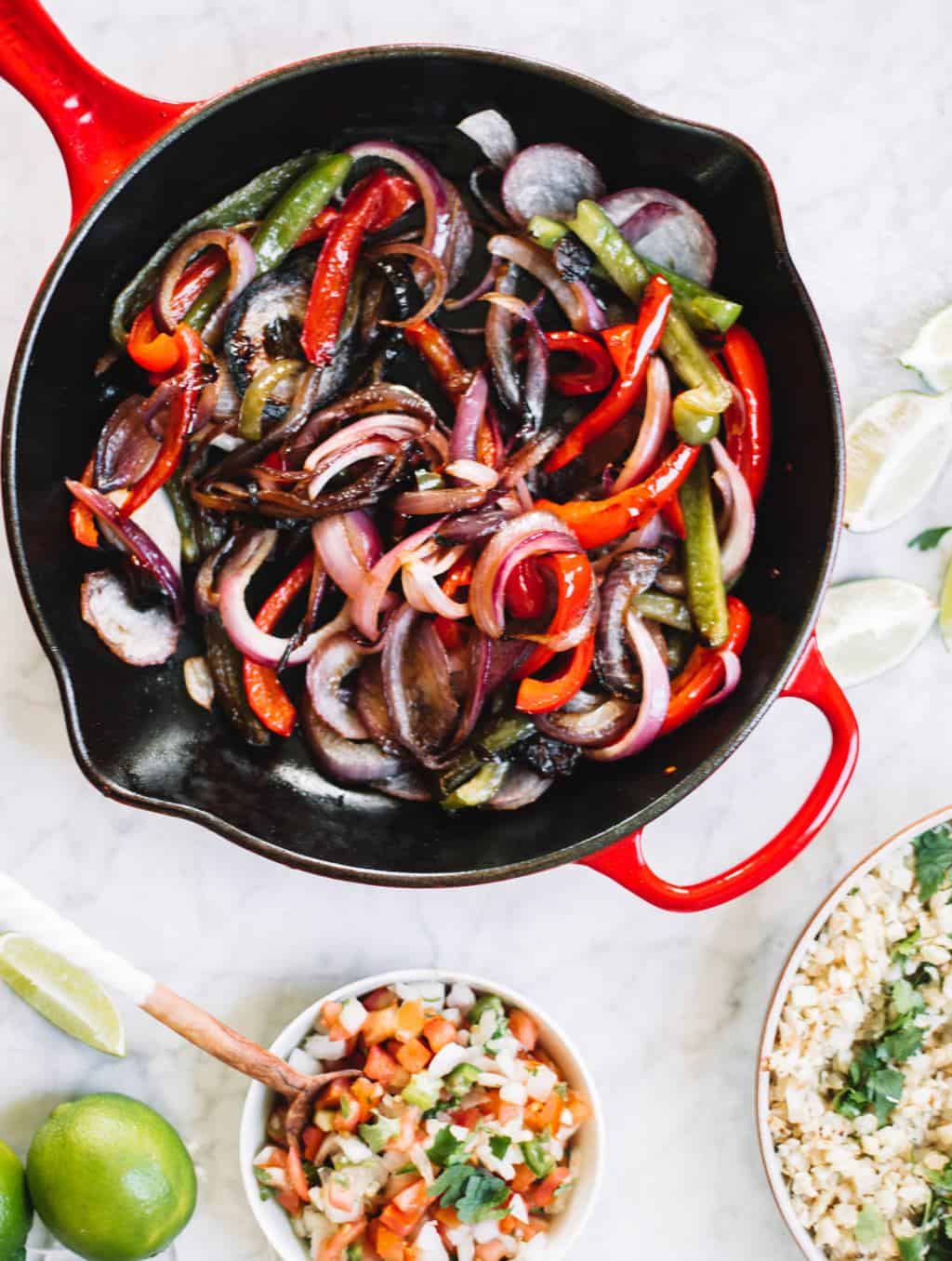 Chipotle style burrito bowls at home or for meal prep! These healthy bowls are made with cauliflower rice, juicy chicken, salsa and avocado crema!