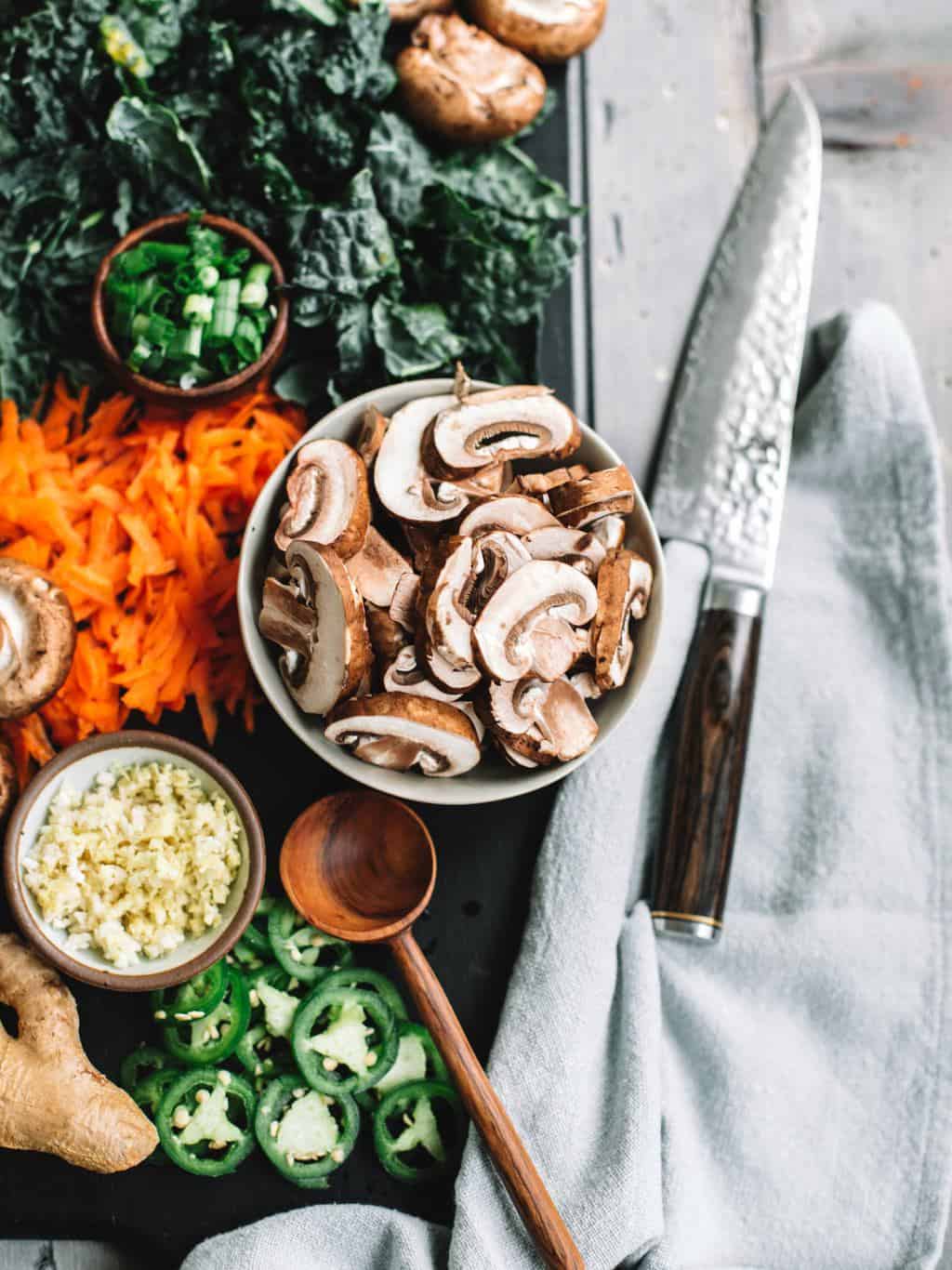 Ingredients like mushrooms, garlic, carrots, kale and green onions for Easy homemade healthy ramen bowls! 