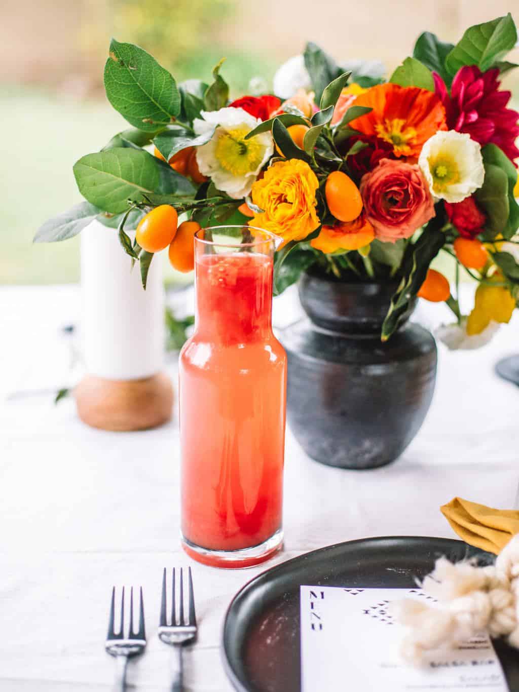 A pitcher of watermelon margaritas on a mexican table setting.