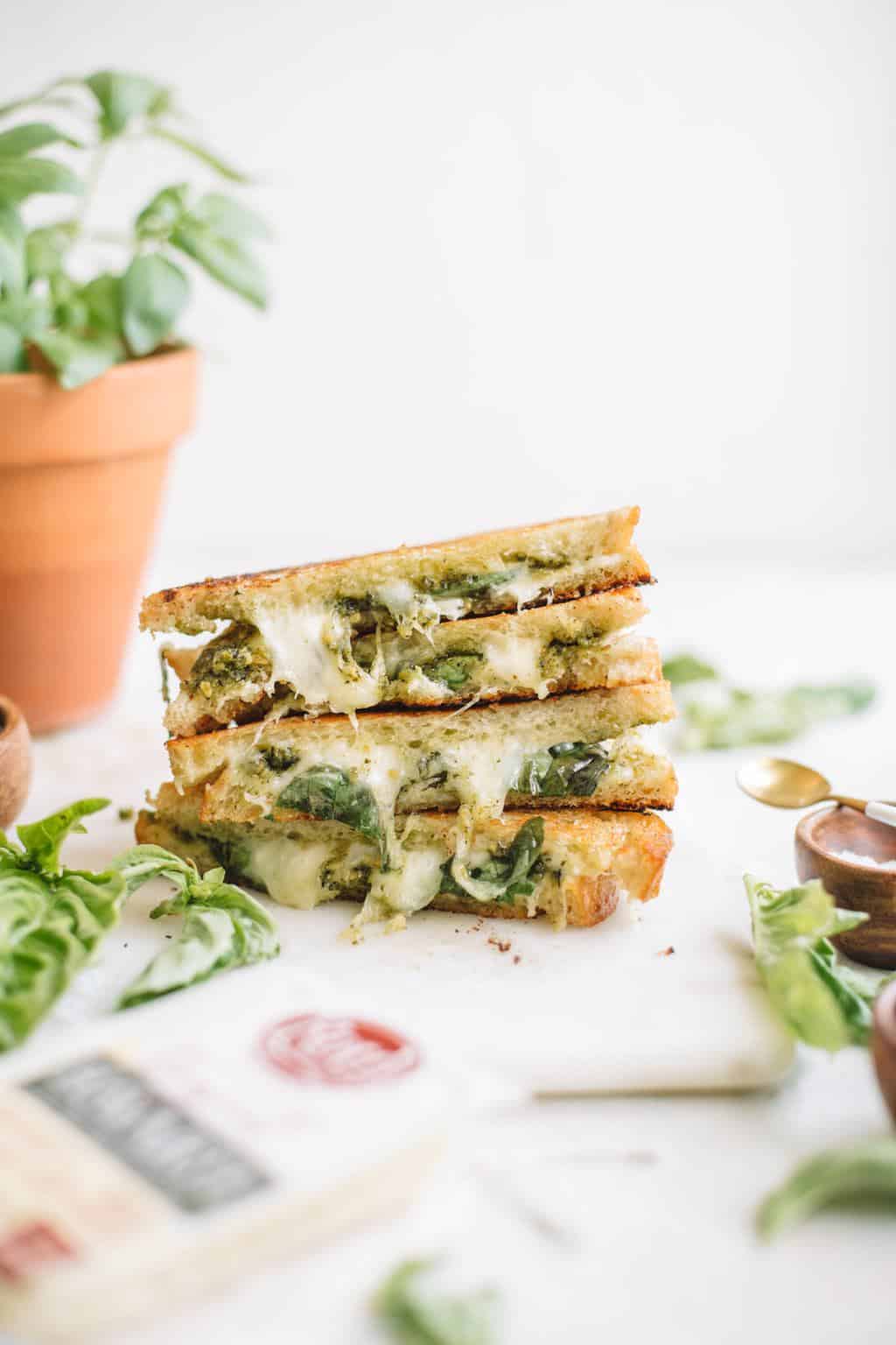 a stack of sliced grilled cheese with pesto