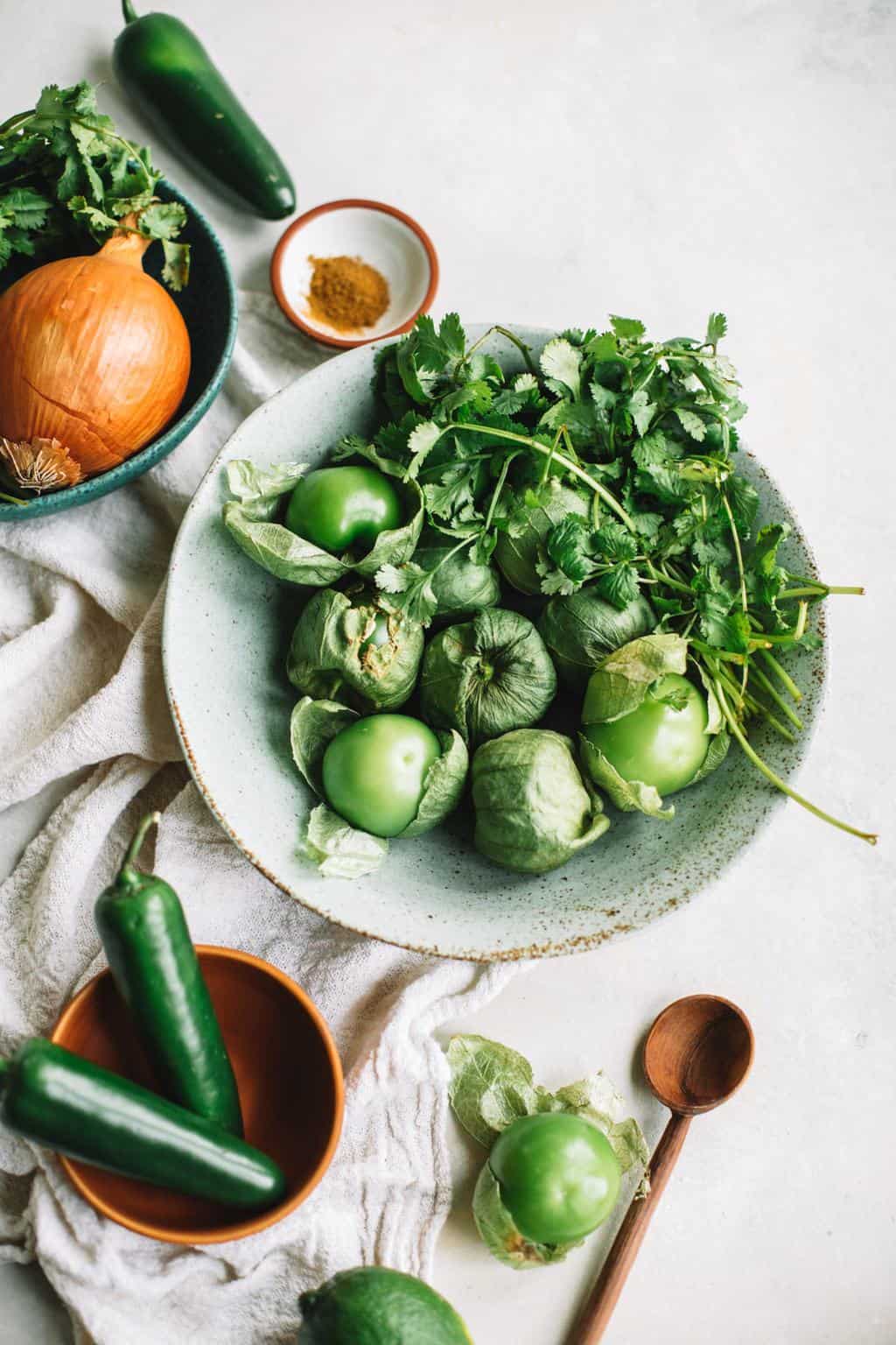 Yellow onion, jalapenos, green tomatillos, cumin and fresh cilantro to make homemade green enchilada sauce.