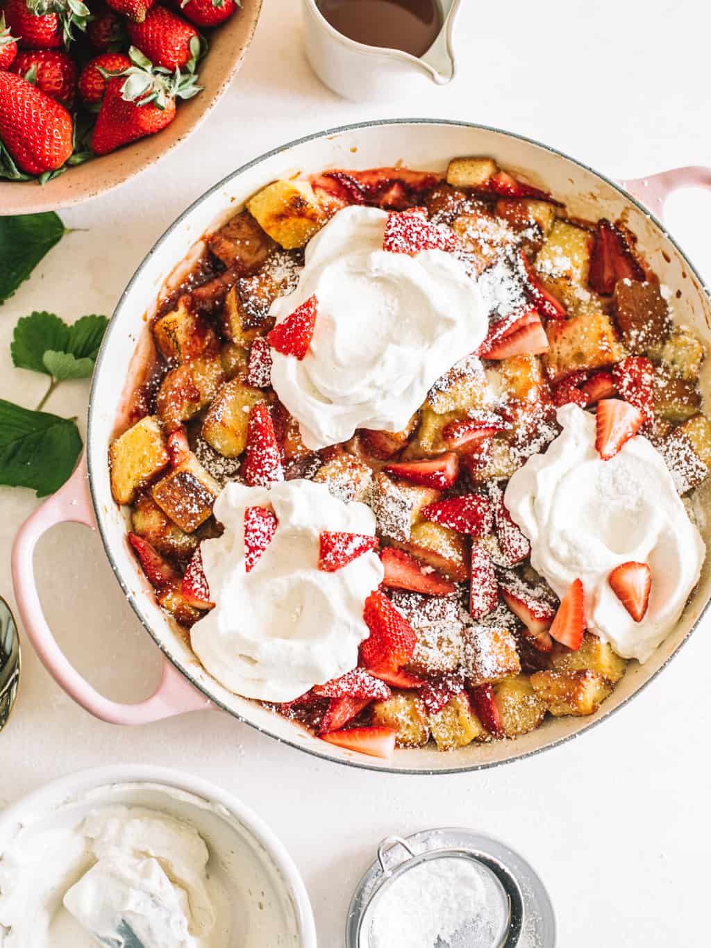 Strawberry and Cream Overnight French Toast in a pink casserole dish