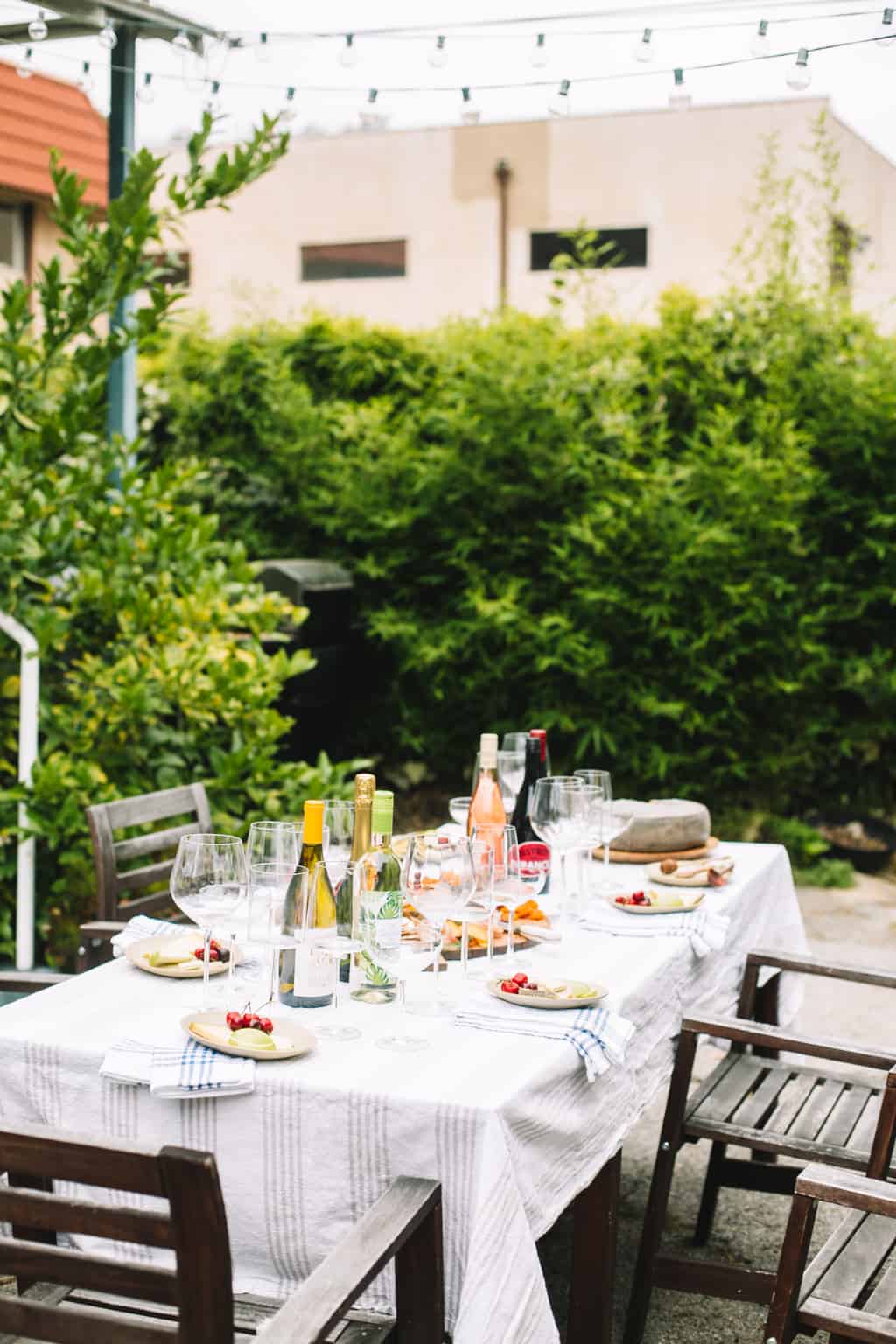 Wine glasses, bottles of wine and and tasting plates.