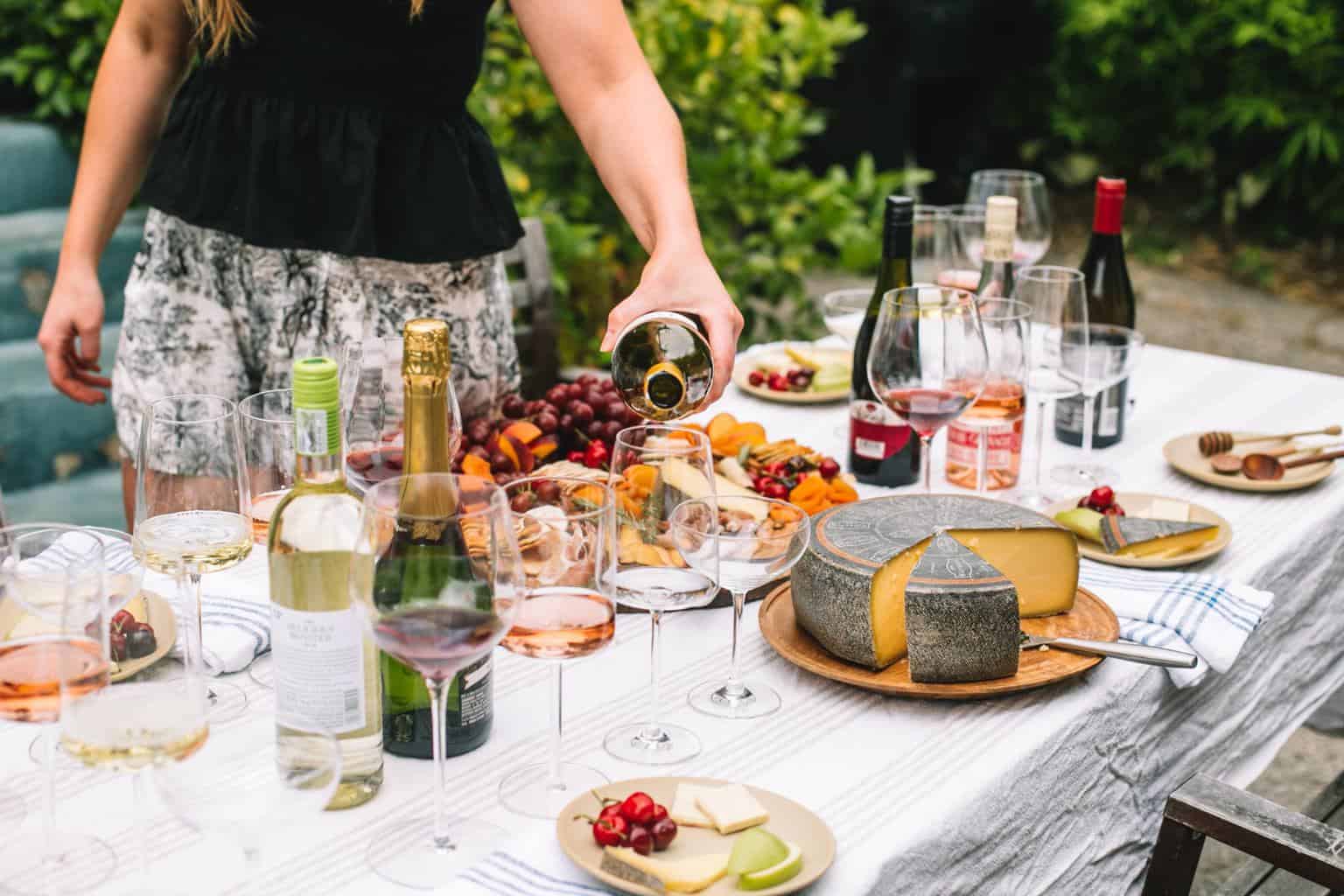 Pouring white wine into a white wine glass.