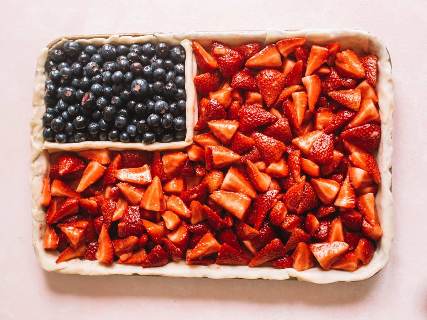 American flag themed pie ready to be topped with pie dough. 