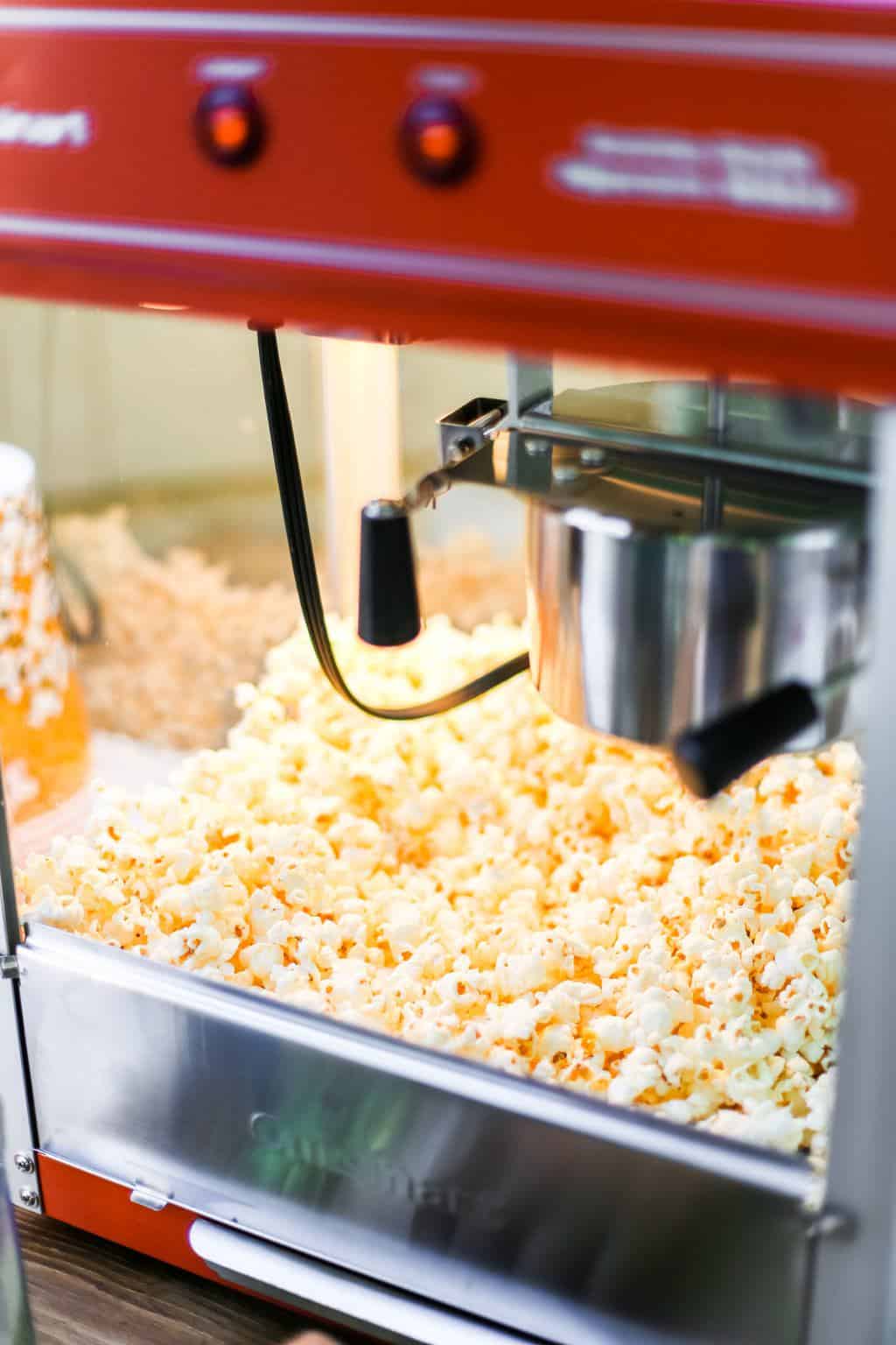 A classic popcorn maker popping popcorn. 