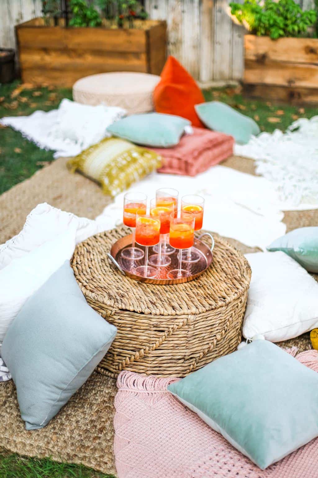 A cozy lounge area with a tray of aperol spritz's for a movie night. 