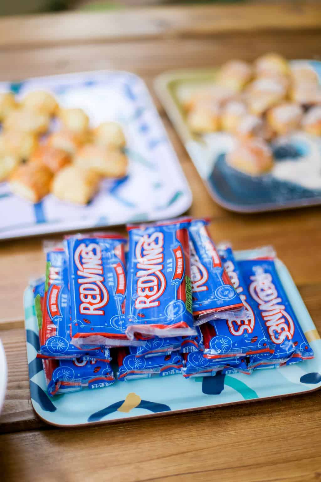 A tray filled with multiple packs of red vines. 