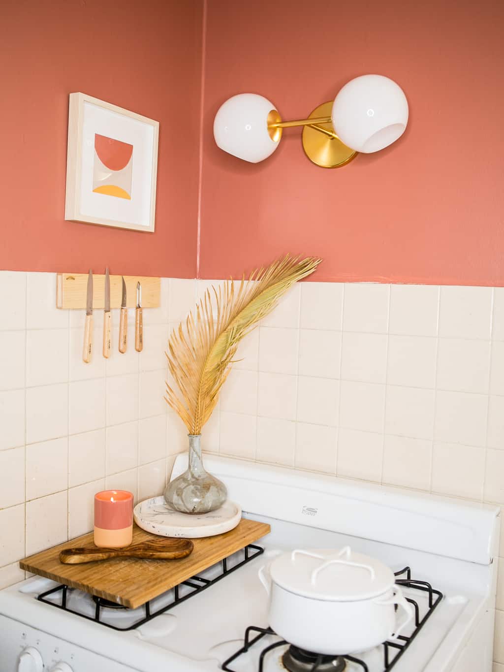 Newly finished stove corner with coral walls and a knife magnet. 