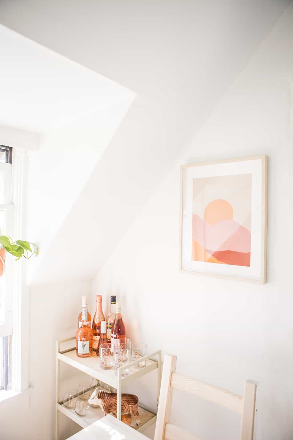 Bar cart with bottles of rosé on it.