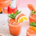 blended frozen cocktail with aperol in glasses with citrus slices and mint