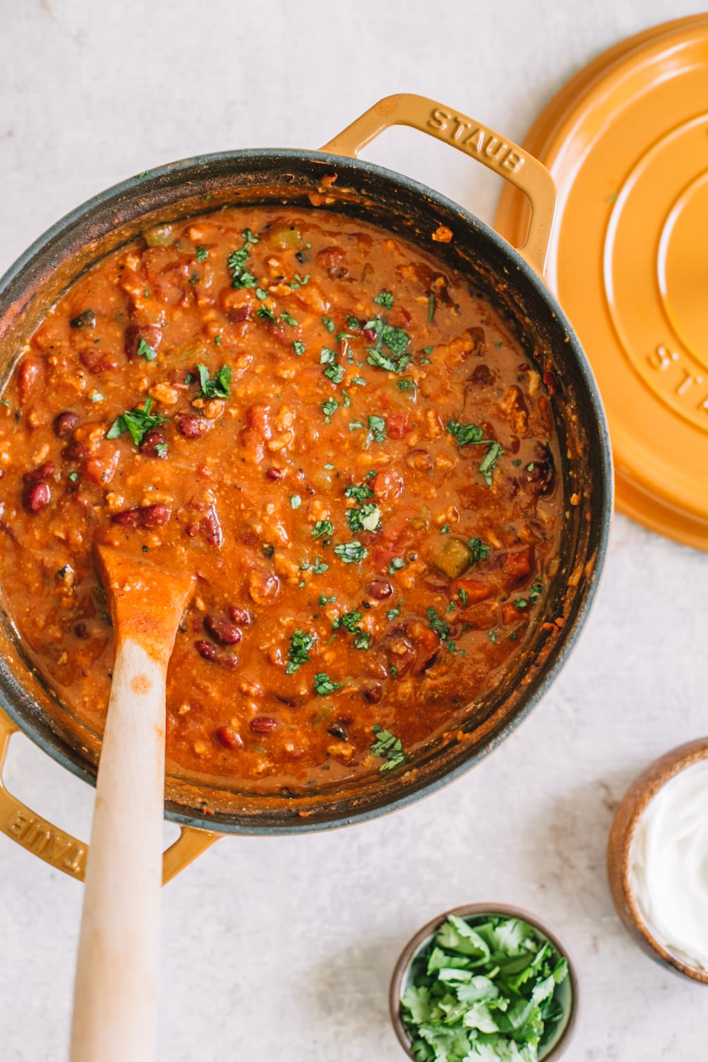 chipotle turkey chili recipe in yellow dutch oven with wooden spoon