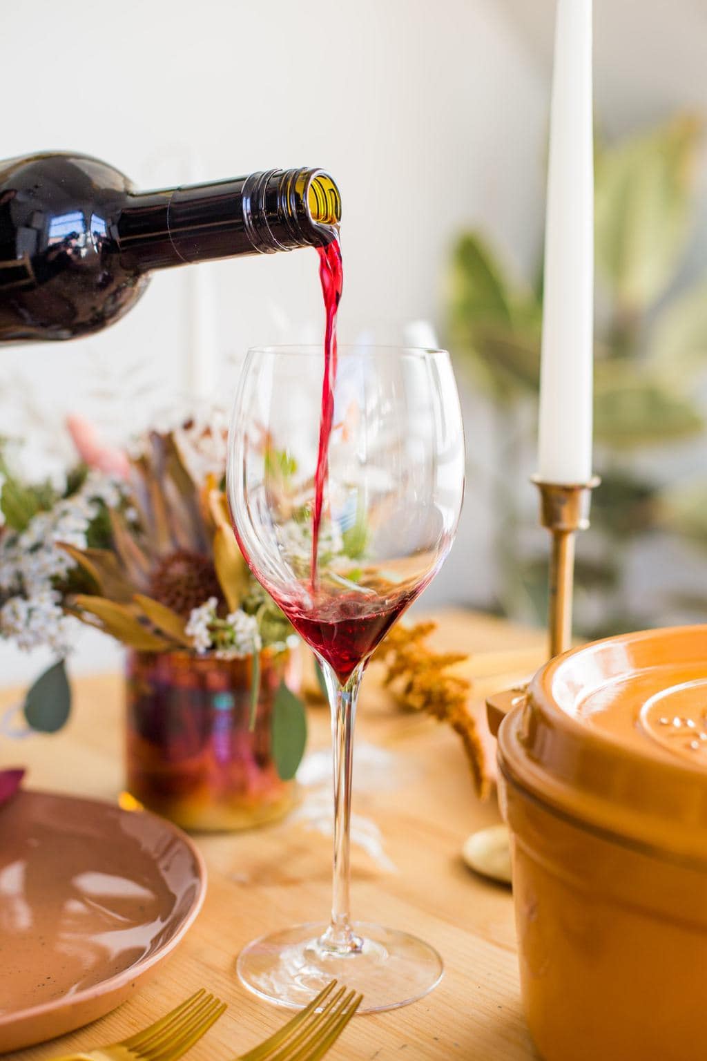 Red wine being poored into a wine glass.