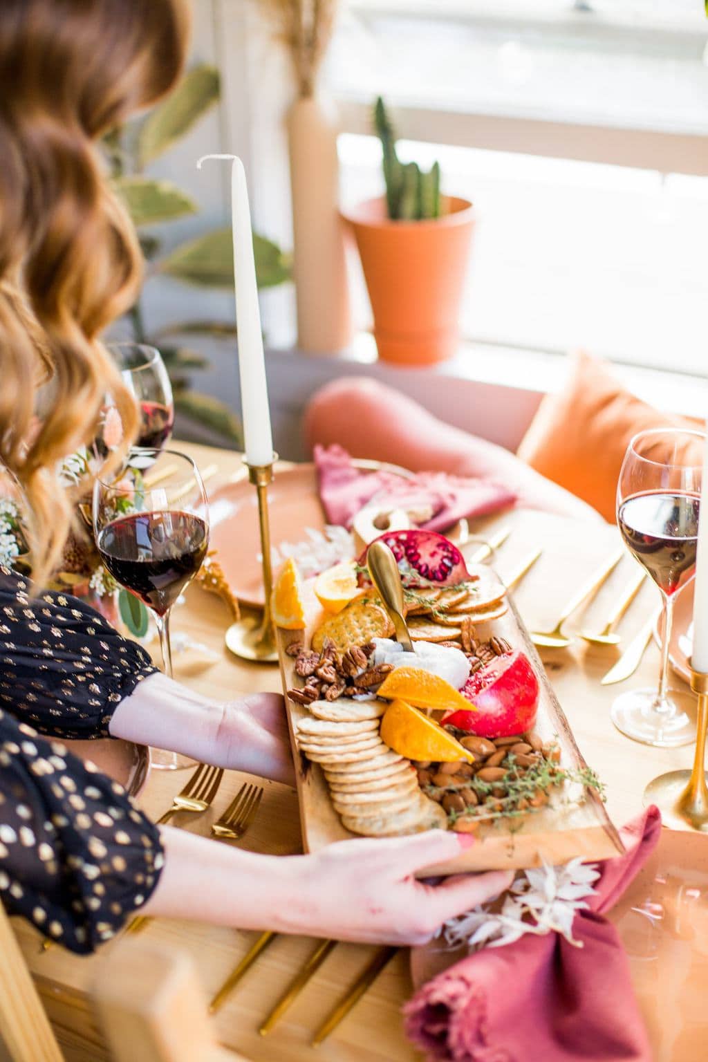 Cheese platter being served on a a table. 