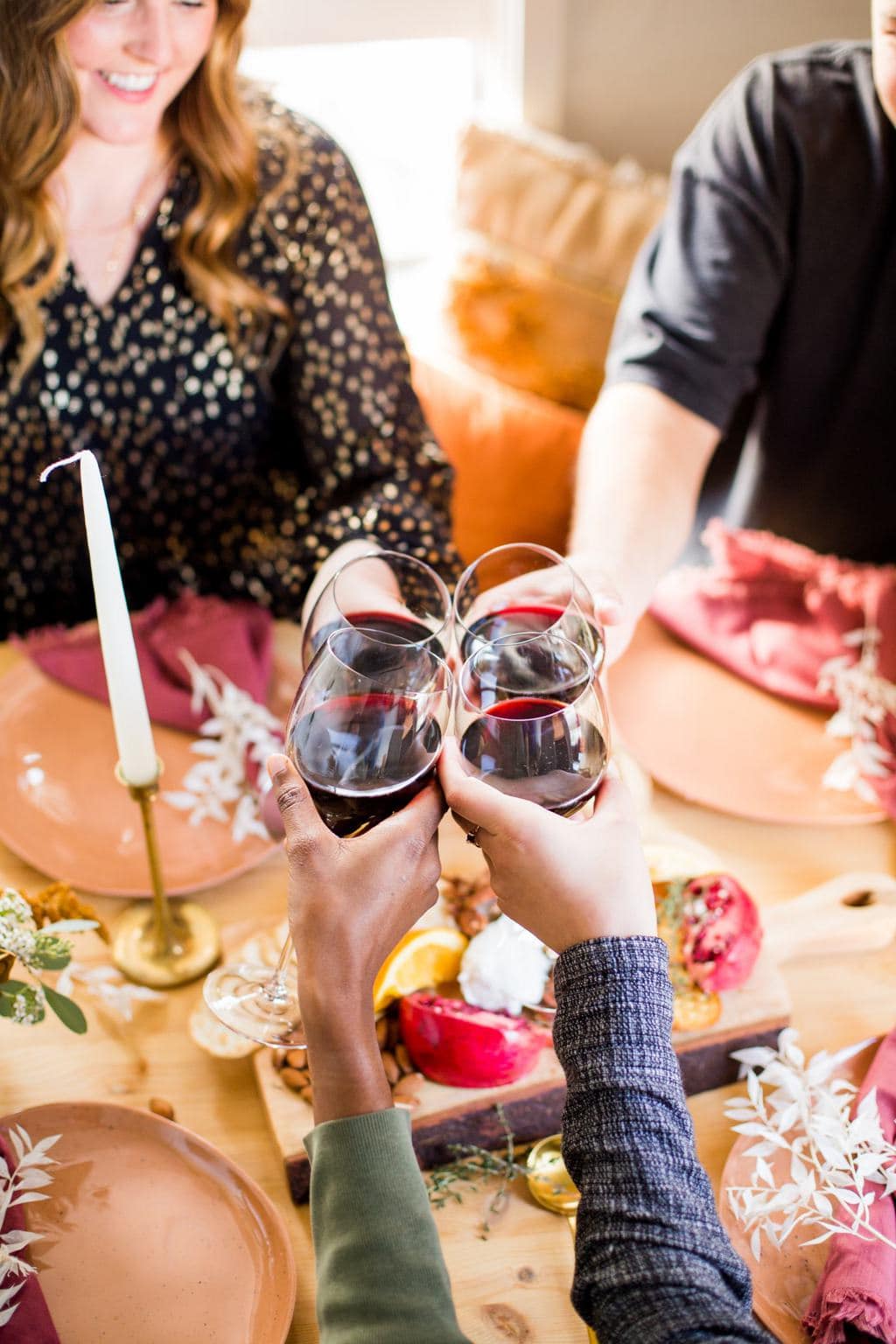 Red wine being cheersed on a table. 