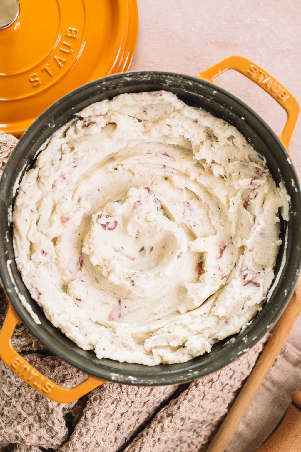 smooth and creamy garlic mashed red potatoes in yellow dutch oven