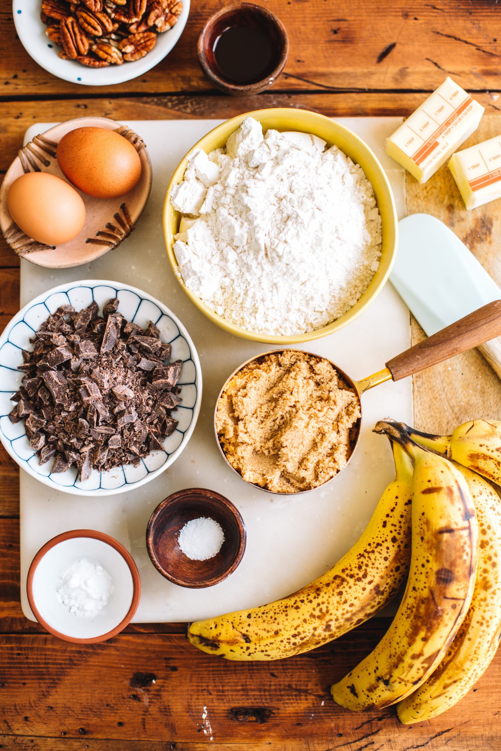 butter, eggs, flour, pecans, brown sugar, chocolate chips, salt, baking soda, ripe bananas