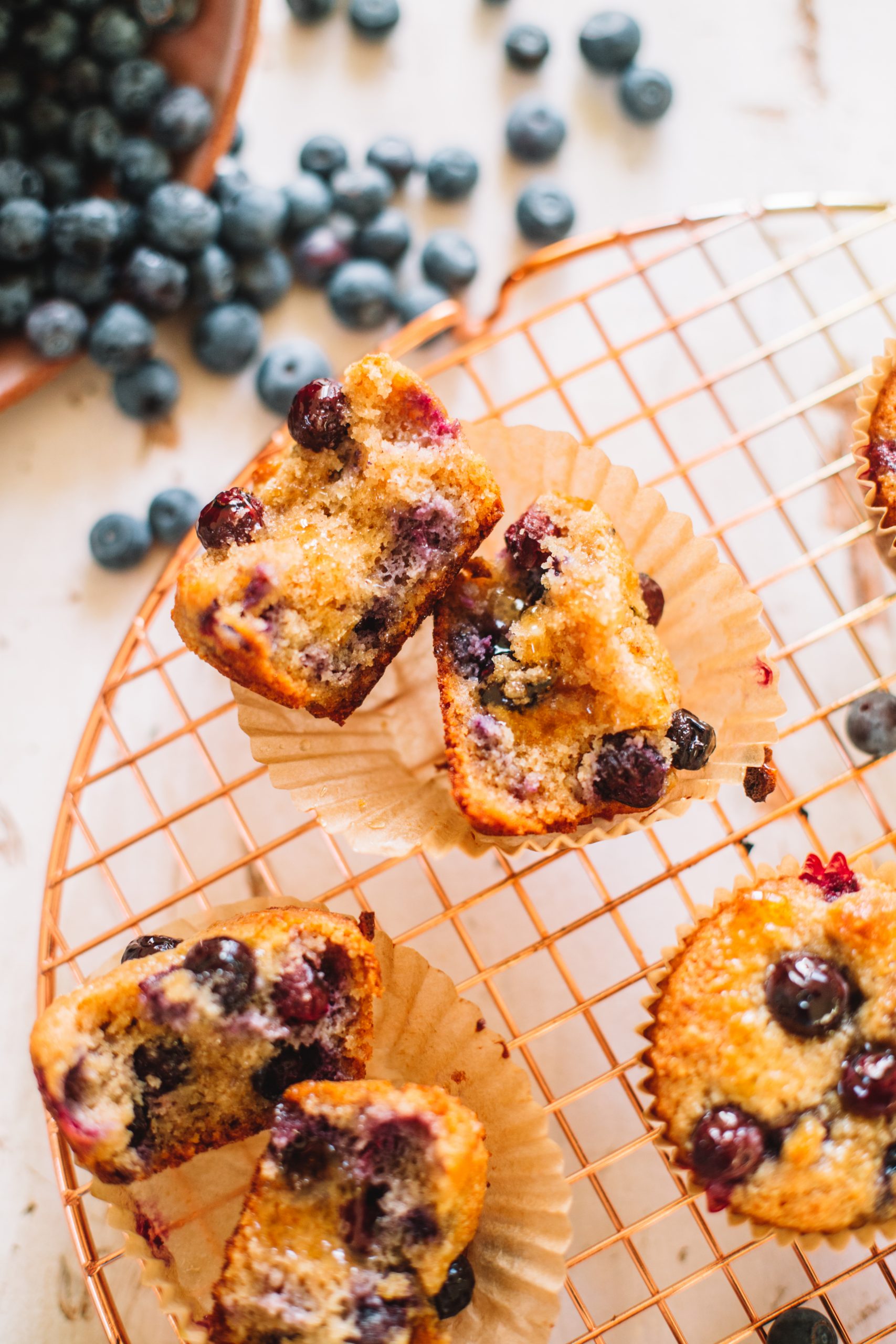 almond flour blueberry muffin split in half on cooling rack