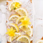 a lemon poppy seed loaf with icing and lemon slices as garnish