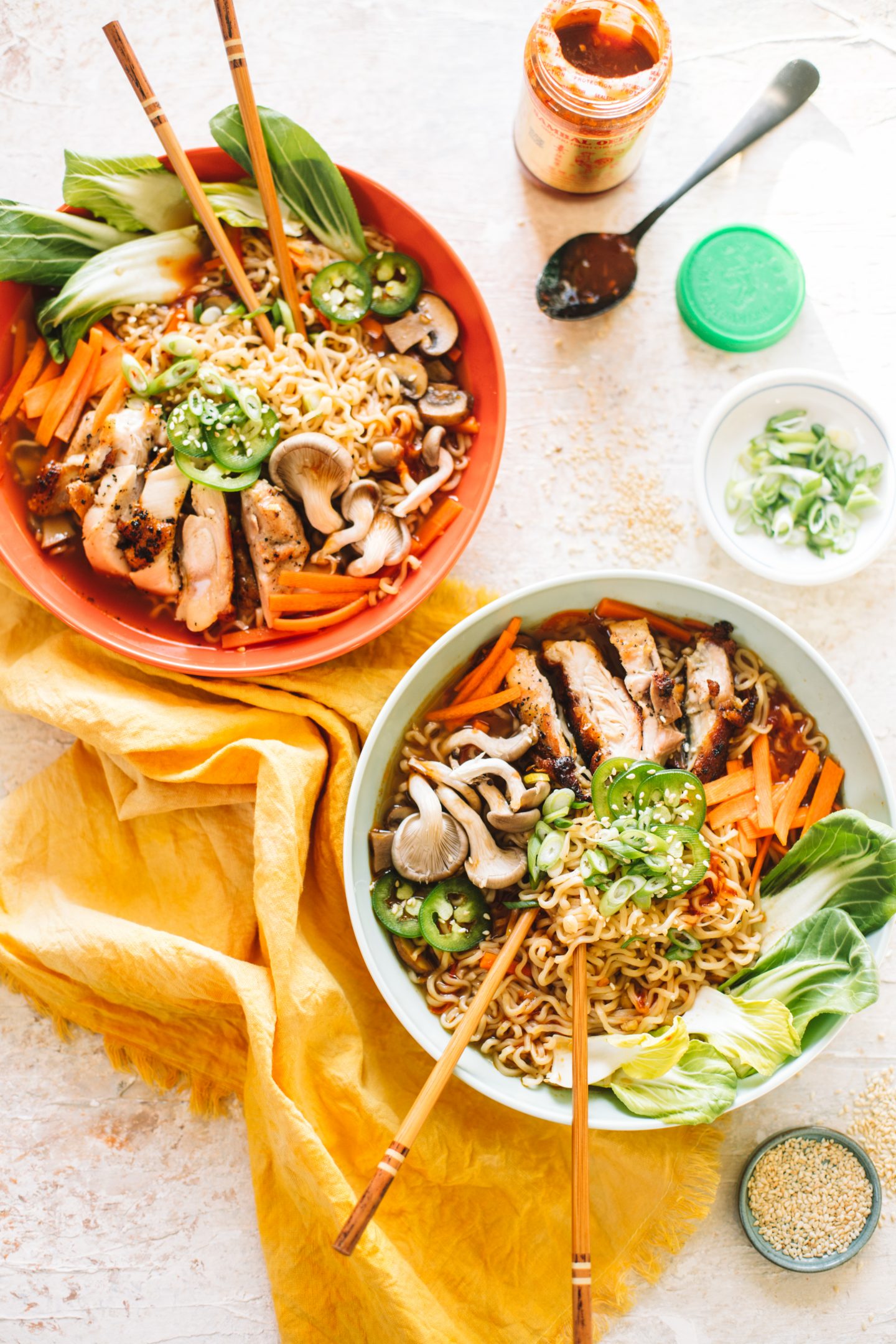 two bowls of chicken ramen soup with chopsticks