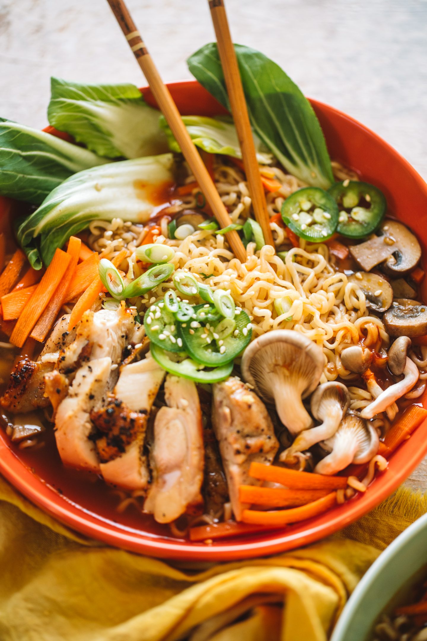 spicy chicken ramen soup in bowl with chopsticks