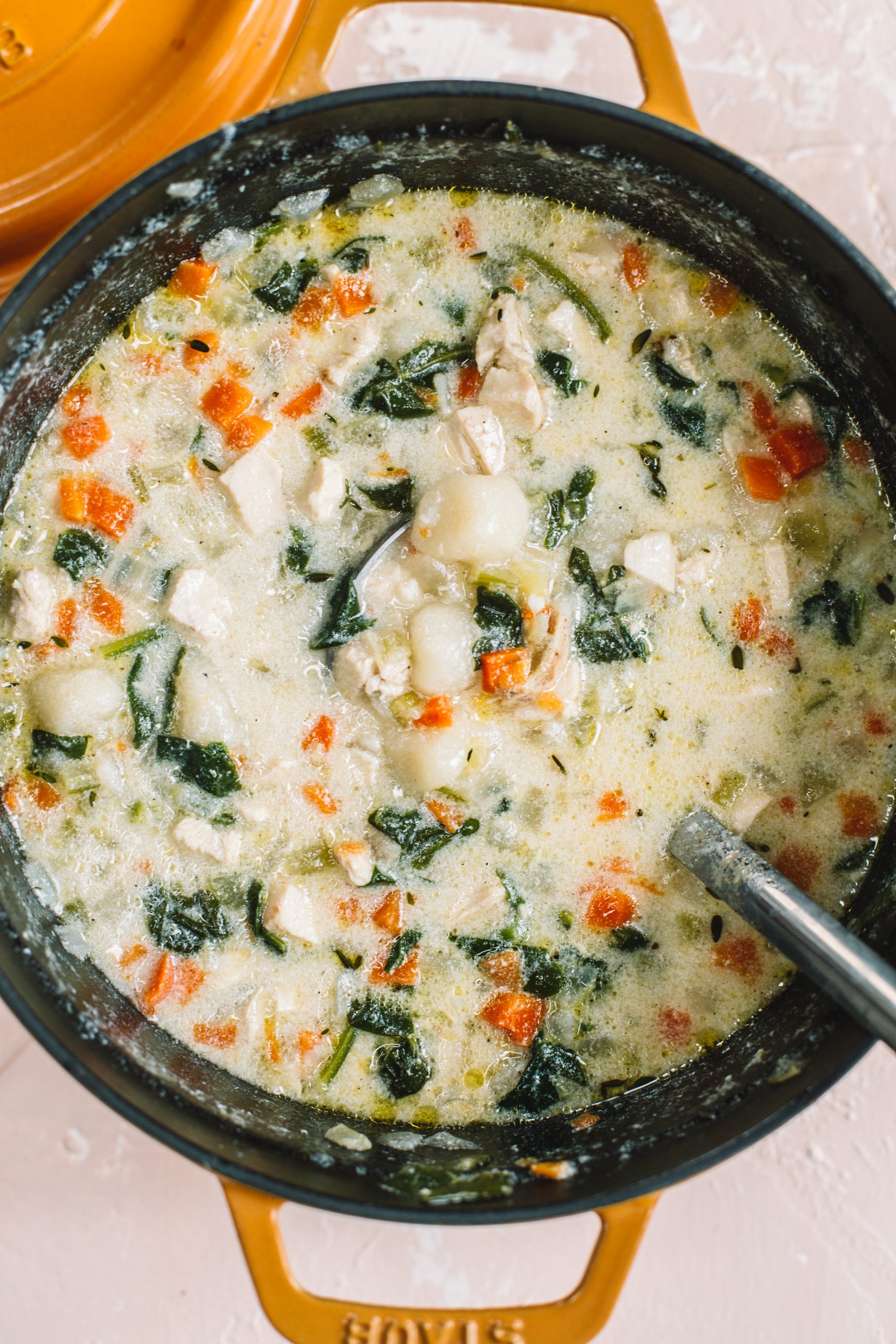 Dutch oven filled with creamy cauliflower gnocchi chicken soup. 