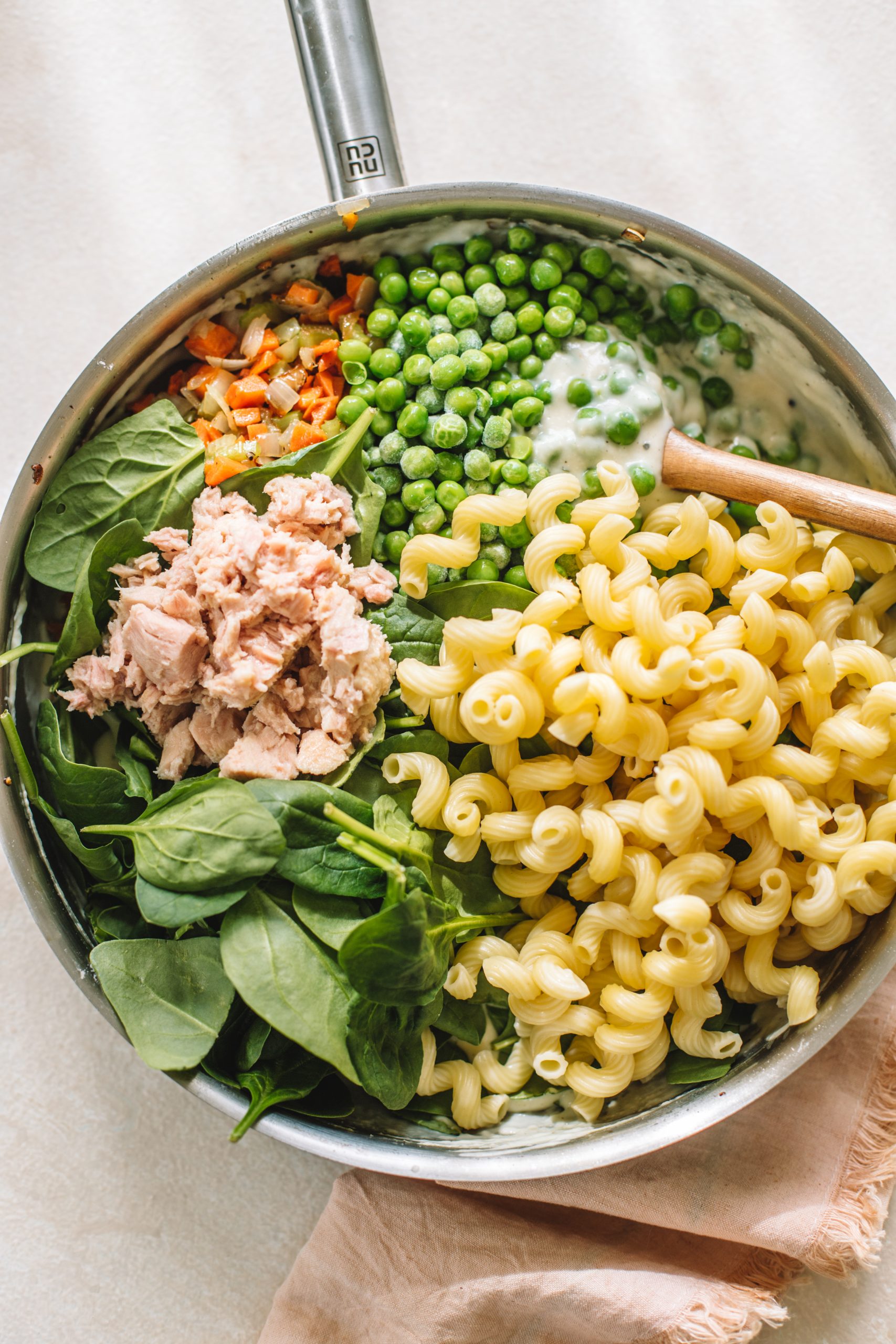 Ingredients for tuna noodle casserole in a skillet ready to be transferred to a casserole dish. 